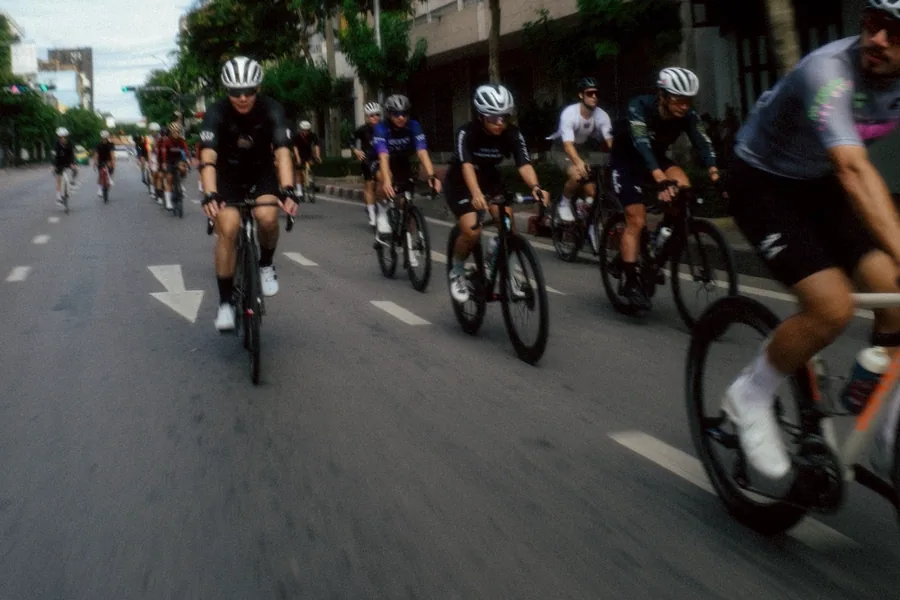 A group of cyclists riding together through city streets